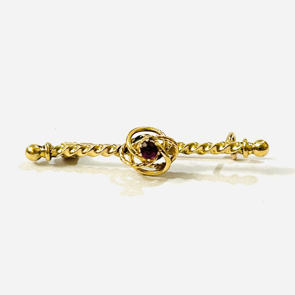 Zlatá starožitná brož s rubínem